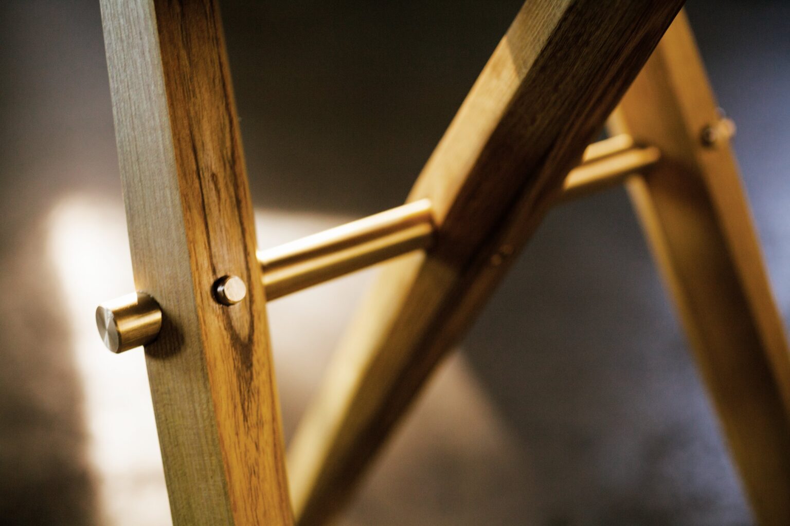 Detail of a wood and metal joint on the stool.