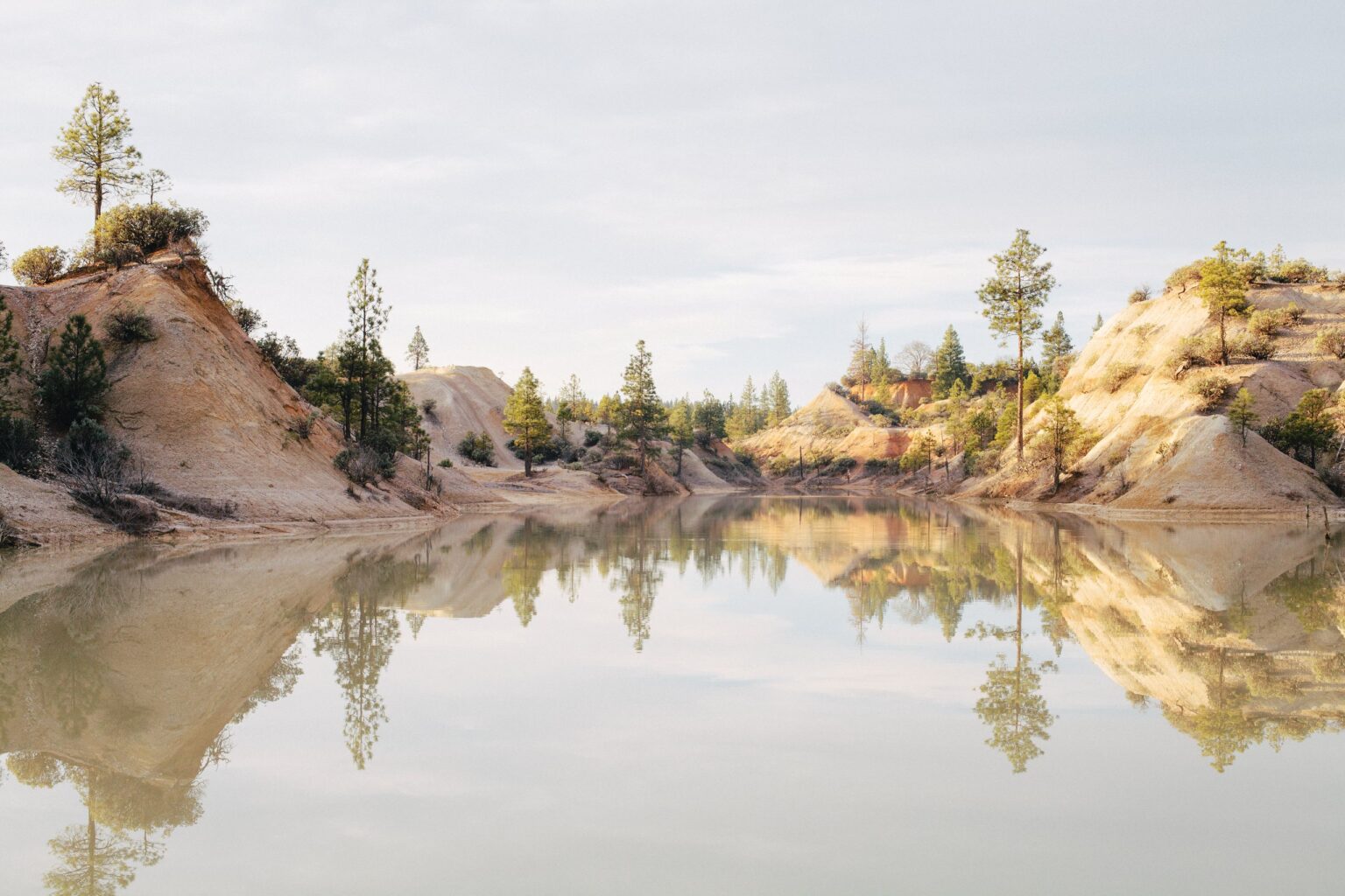 The hillsides of the Diggins reflected in water.